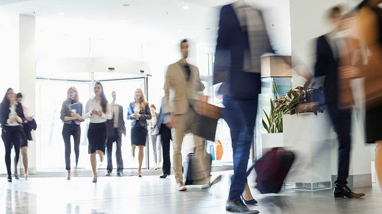 Blurred motion of business people walking at a office lobby.