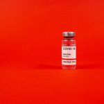 vaccine vial on red background