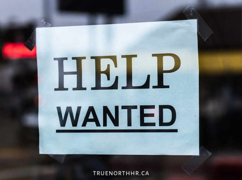 Window with 'Help Wanted' sign