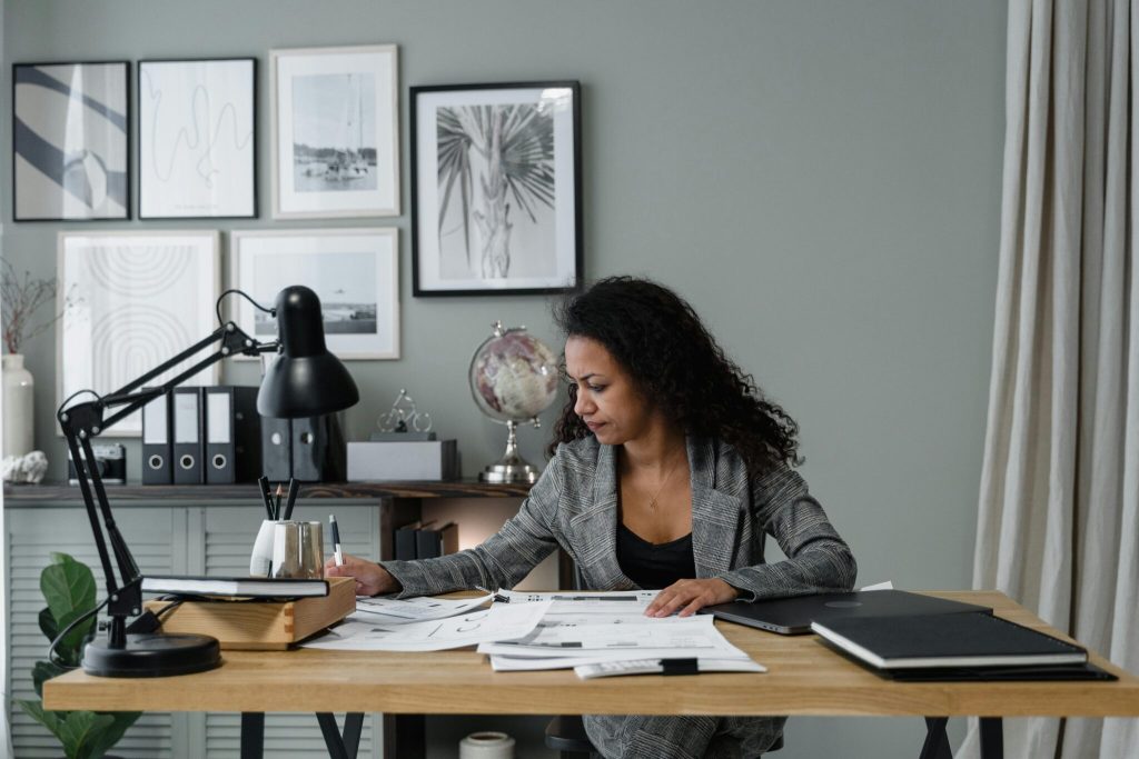A business woman focused on work at her desk.