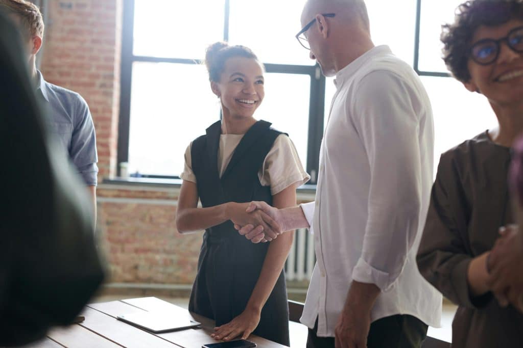 woman and man shaking hands